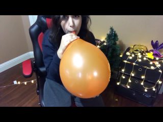 having fun blowing up a balloon and popping it