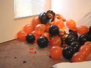 two lesbians popping balloons